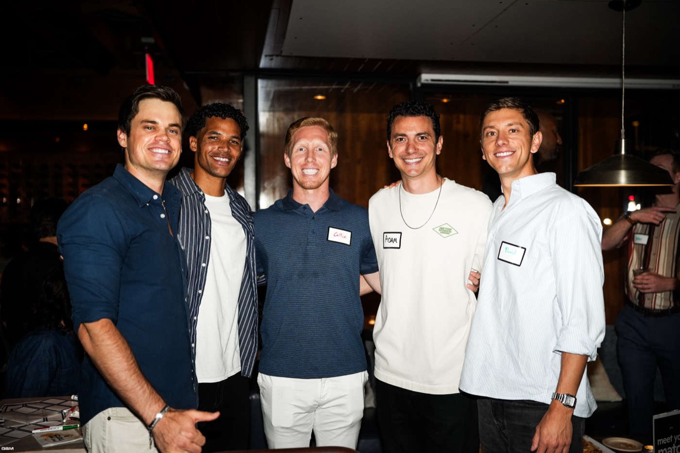 A group of former teammates posing at the bar