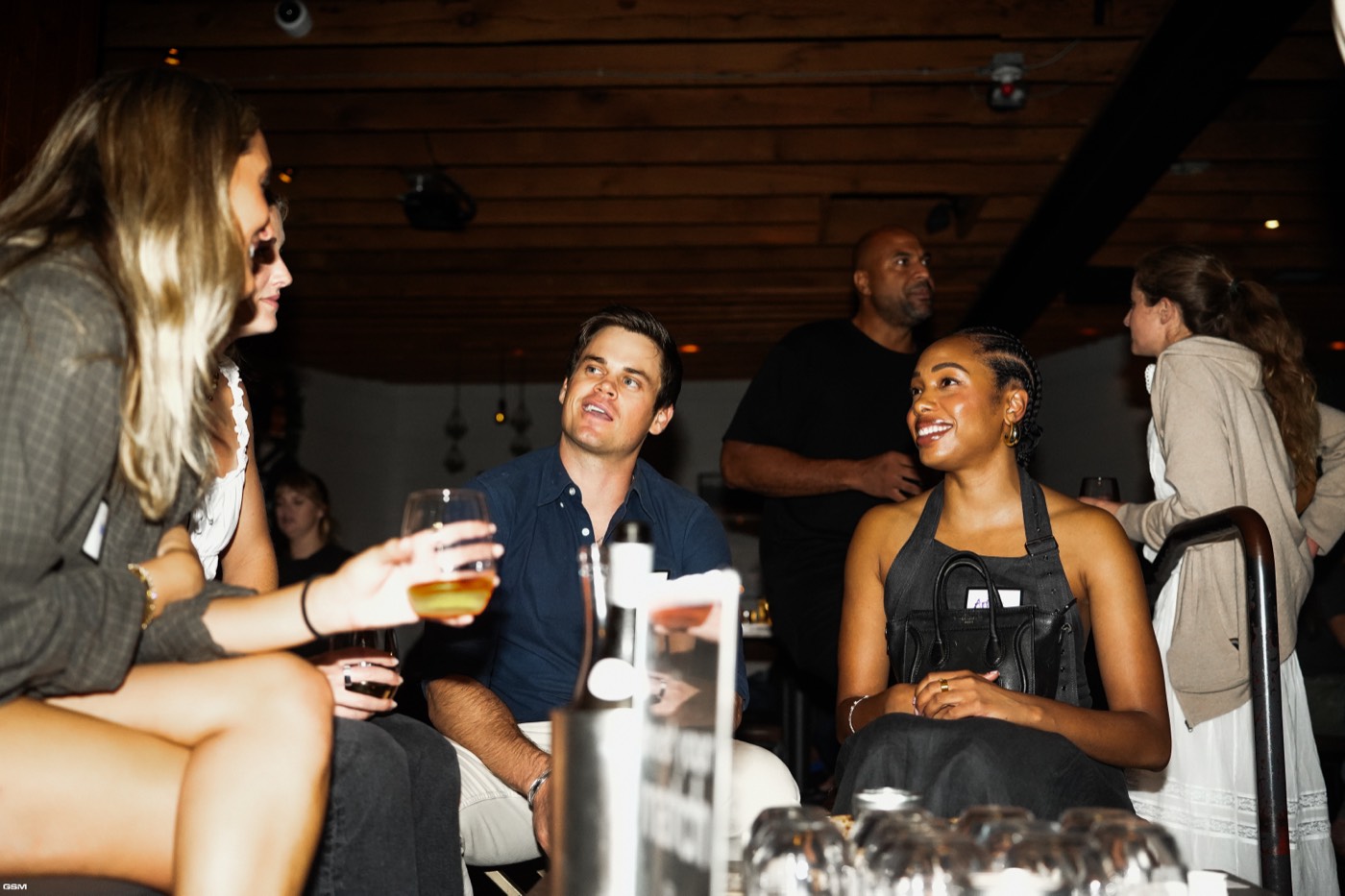 Guests chatting over drinks at Bodega
